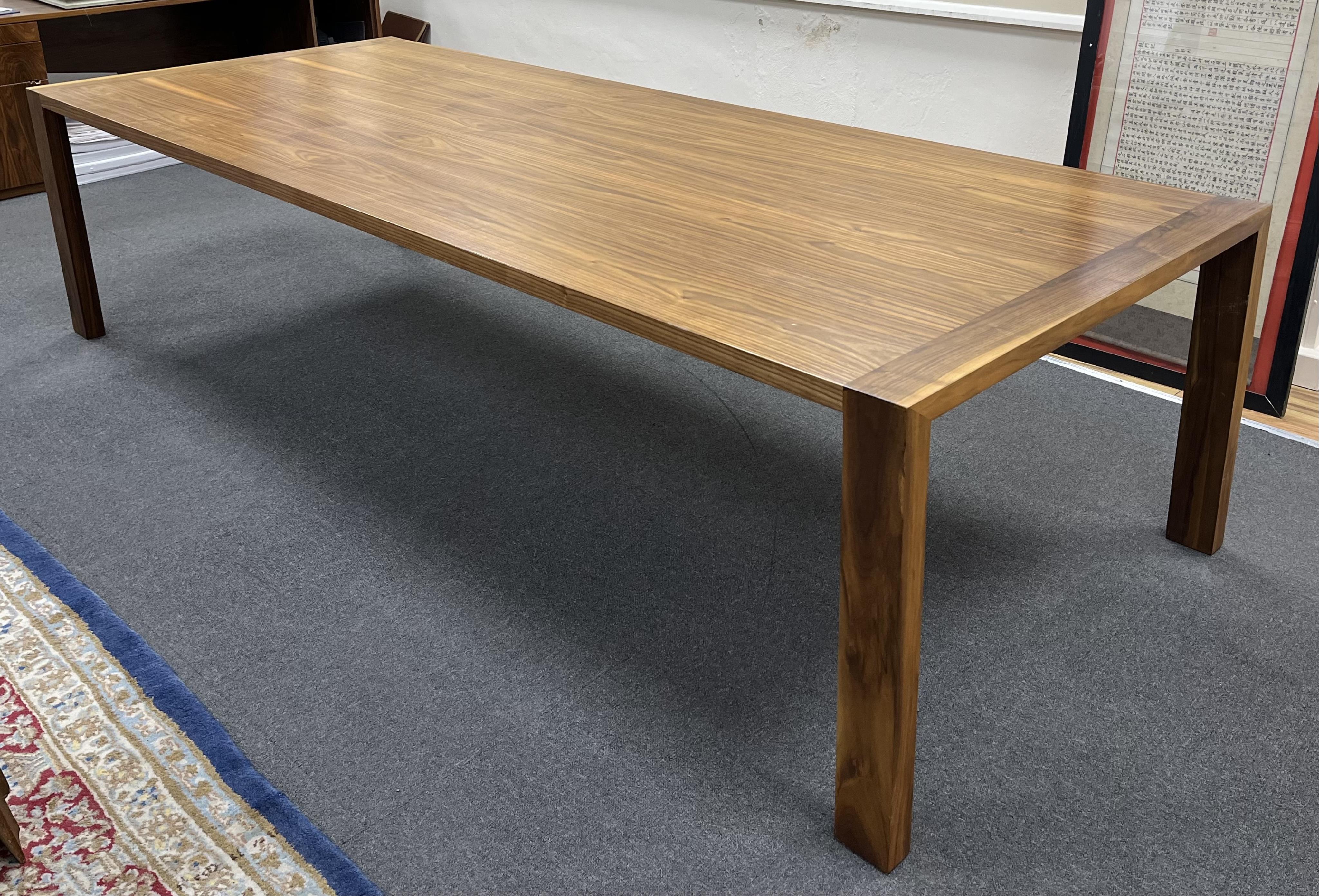 A Contemporary American black walnut dining table and ten chairs, by Chartwood designs Ltd, width 300cm, depth 120cm, height 75cm. Condition - fair